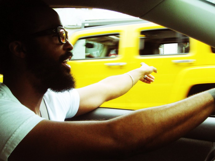 Bradford Young passes a Hummer while behind the wheel